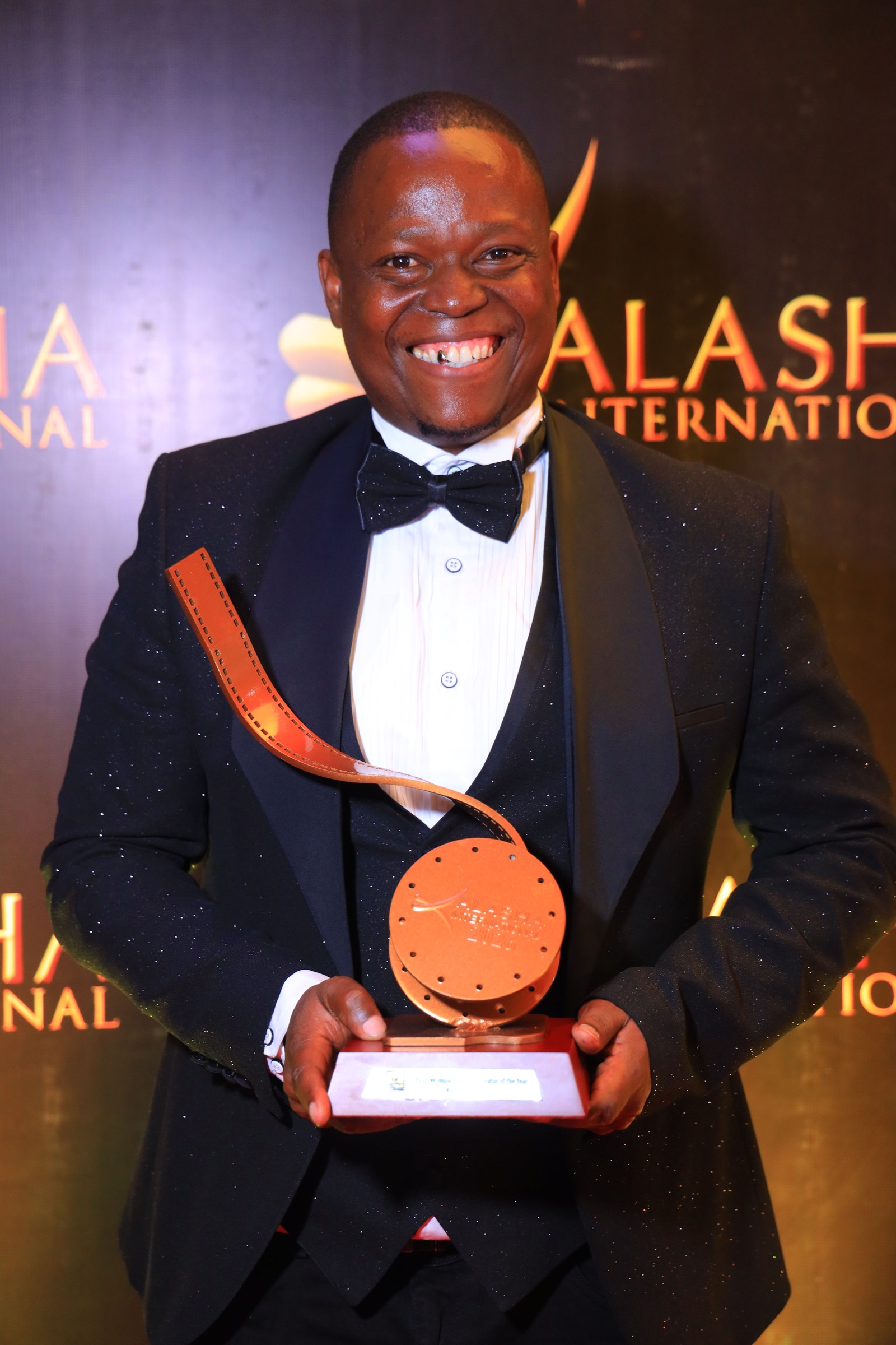 Ali Sisei holding a film award at the Kalasha International Film and TV Awards