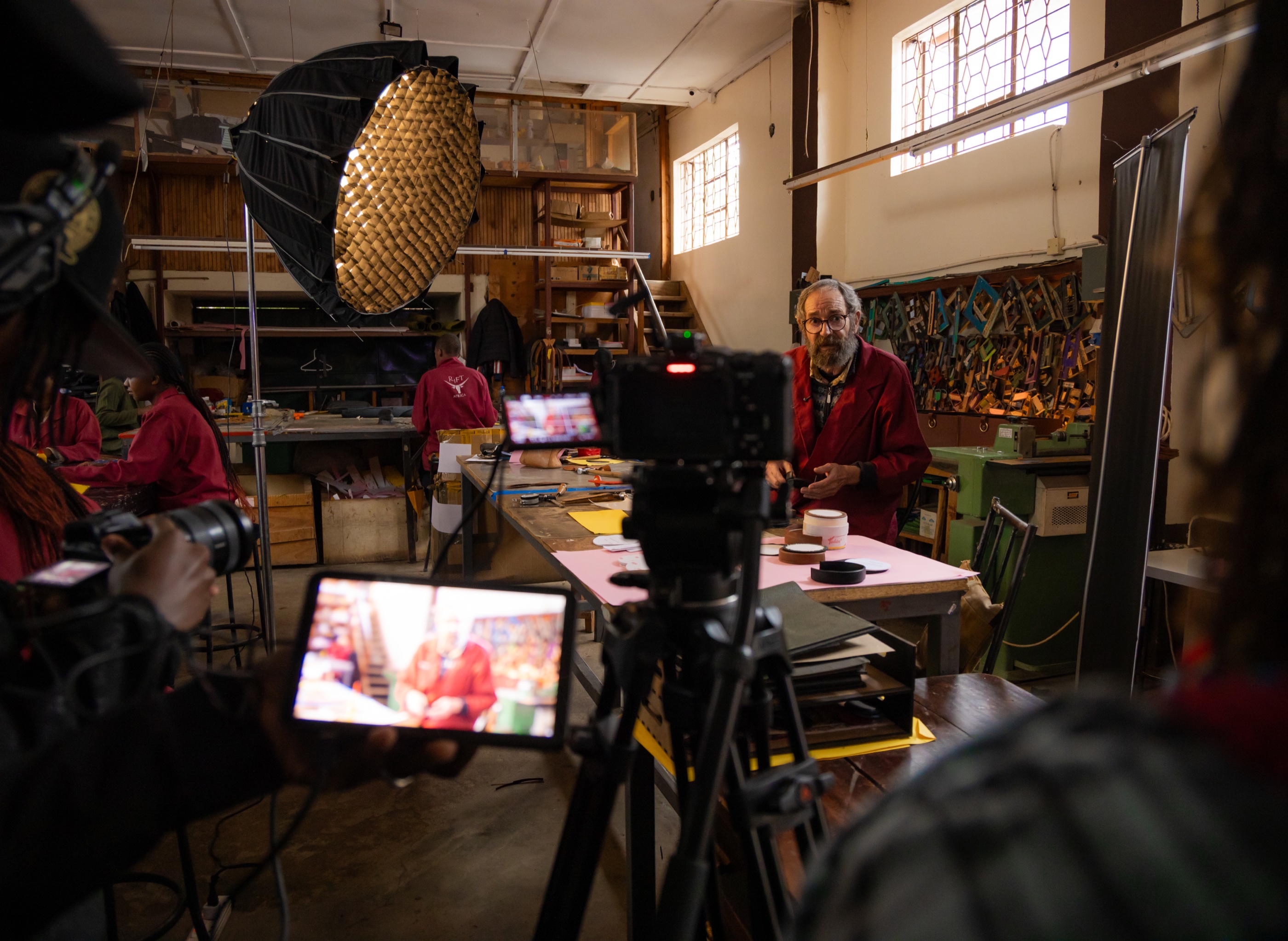 Film crew recording an artisan in his workshop