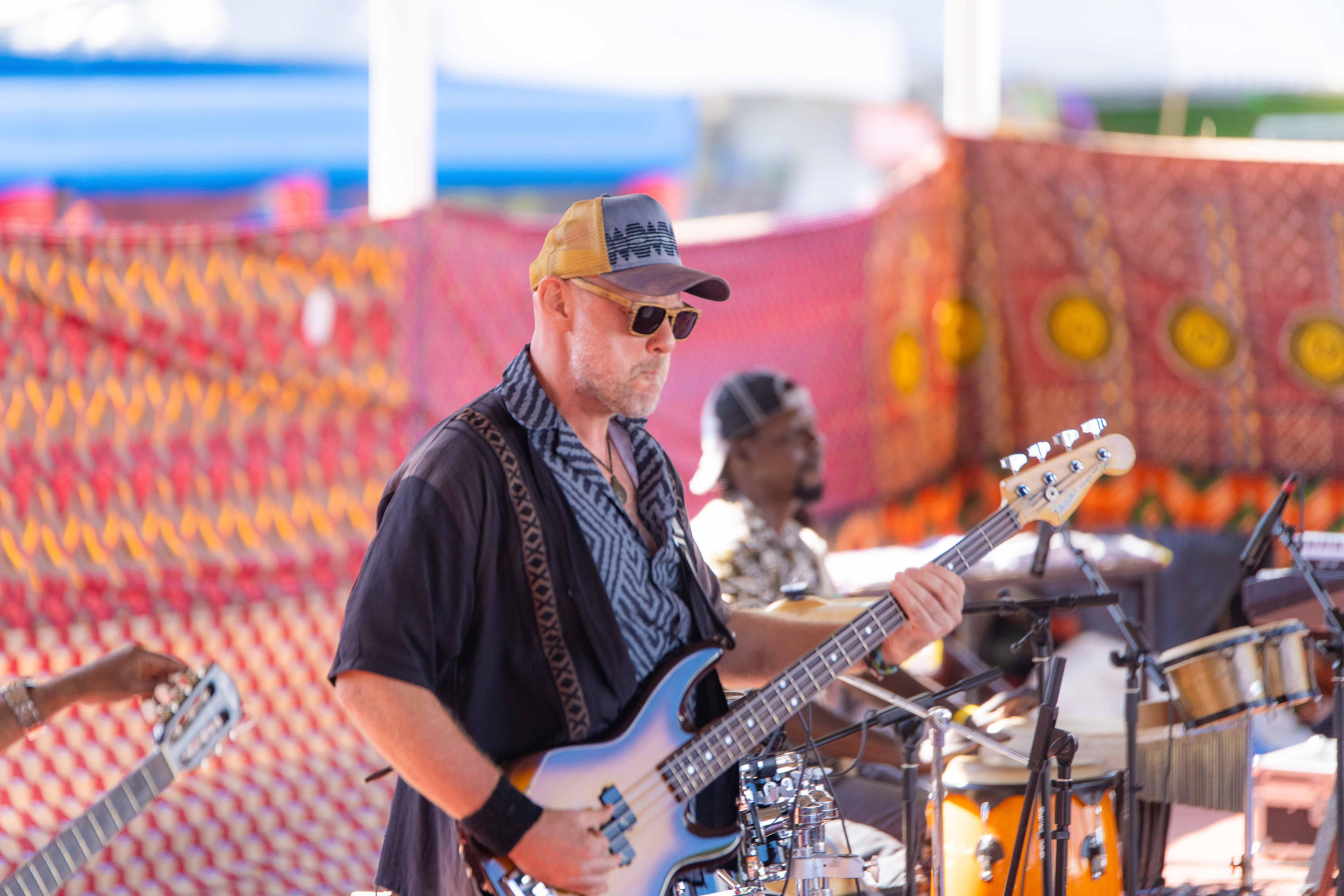 Guitarist performing during event coverage